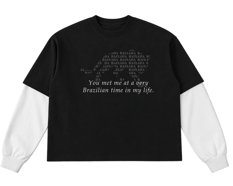 The black Baixada tee with cream long sleeves, printed with a jaguar formed from the word Baixada and the line: You met me at a very Brazilian time in my life.